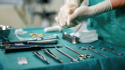 Fototapeta na wymiar Surgeon preparing medical equipment for an operation