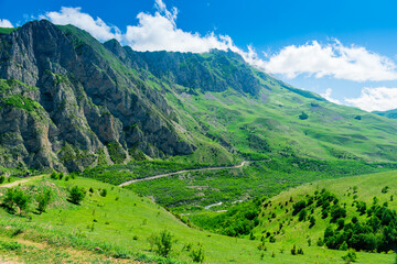 Naklejka na ściany i meble Green valley on the site of the collapsed Kolka glacier. Karmadon Gorge in the mountains of the North Caucasus. Russia