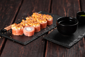 Sushi roll philadelphia with salmon and cream cheese on black background close-up. Sushi menu. Japanese food concept