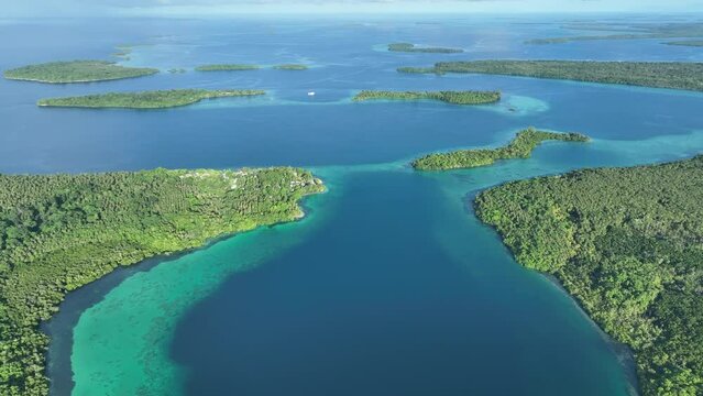 Healthy coral reefs fringe lush islands in the Solomon Islands. This beautiful, tropical country is home to spectacular marine biodiversity and many historic WWII sites.