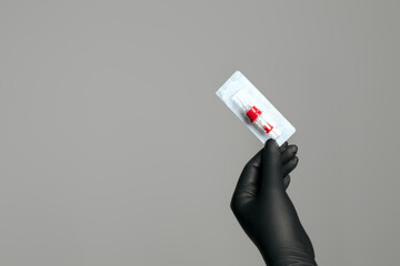 Permanent makeup master in gloves holding sterile cartridge