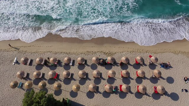 Aerial top view video of popular tropical paradise deep turquoise Mediterranean sandy crowded beach