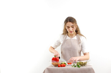 Beautiful young woman preparing vegetable salad in the kitchen. Healthy food. Vegan salad Diet concept. Healthy lifestyle. Cook at home. Prepare food close-up, only hands, olives, tomato, cucumber