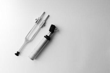 tuning fork C 128 on a white background with gradation and otorhinoscope