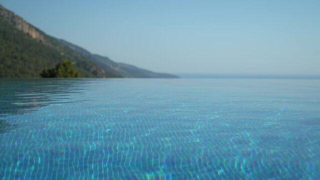 Clean Swimming Pool and Green Mountains in Background 4K