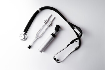 tuning fork C 128 on a white background with gradation, otorhinoscope and stethoscope