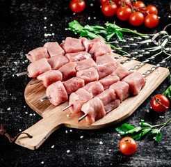 Fresh raw pork kebab on a cutting board. 
