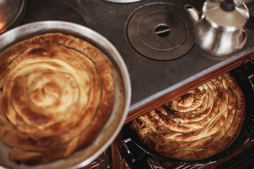 Roll pastry cooked in a wood stove. Title: on a white background Turkish Tepsi Boregi, Round Borek, Tray pastry (Turkish name; rulo borek)
