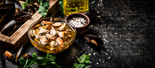 Pickled mussels with parsley and spices on the table. 