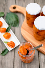 tasty tangerine jam in glass jar on wooden table.ball of tangerine jam
