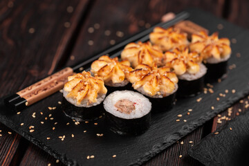 Maki sushi roll with eel served on black board close-up - Japanese food