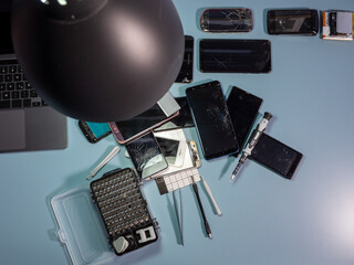 Old broken smartphone and repair tool. The concept of computer equipment, mobile phones,...