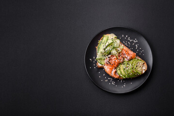 Fresh tasty sandwich with salmon, avocado and sesame and flax seeds