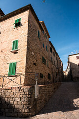 Fototapeta na wymiar Italy, Volterra, August 15 2021: Charming little street of Volterra town in Tuscany, Italy, Europe