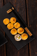 Sushi roll with eel, avocado and cream cheese served on black board top view - Japanese food