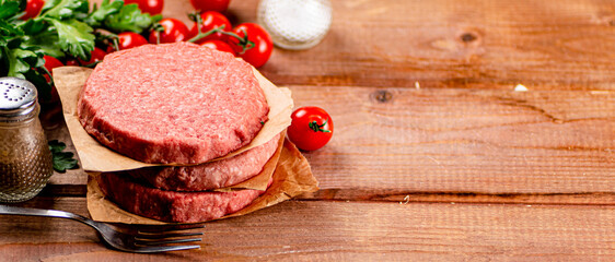 Raw burger with fresh tomatoes. 