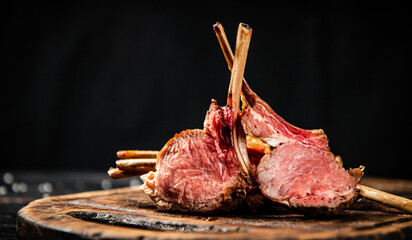 Rack of lamb grill on a cutting board.  - 563403436