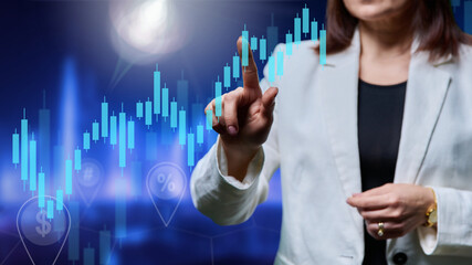 Close-up of business woman's hands touching virtual screen with charts