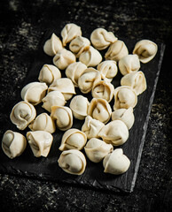 Raw dumplings on a stone board. 
