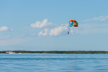 a parasailer in the blue sky over the sea 