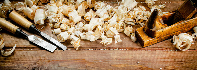 Working tool on wood on with shavings. 