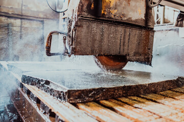 A stone cutter processes stone and granite slabs in the industry