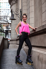 Teenage girl on roller skates. Portrait of young caucasian blond woman on urban environment wearing roller skates. Female skater. Female sportive model.