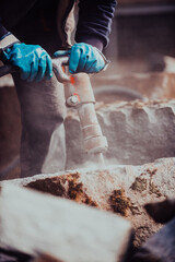A stone pierces a factory worker. Heavy stone processing industry