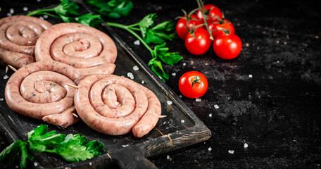 Raw sausages with parsley and tomatoes.