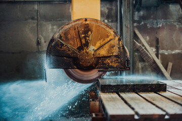 A stone cutter processes stone and granite slabs in the industry
