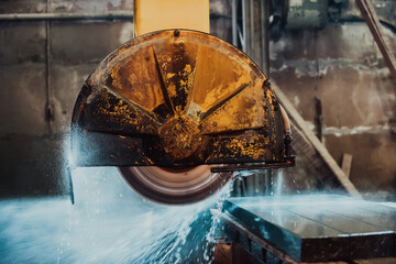 A stone cutter processes stone and granite slabs in the industry