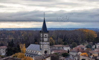 Fototapeta na wymiar Small old town and Church in Mauves, France. Cloudy Moody Sunset Sky.
