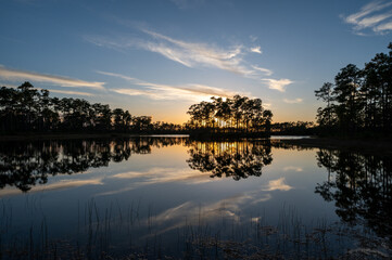 Obraz premium Sunset cloudscape over and reflected in water at Long Pine Key in Everglades National Park, Florida.