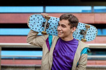 A teenager skateboarder. Skateboarding lifestyle. Male teenager with a skateboard wearing casual clothing. Skater boy portrait. © Luluraschi