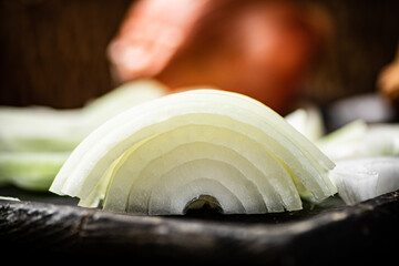 Pieces of onions on a cutting board. 
