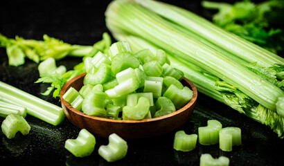 Pieces of fresh celery in a wooden plate. 