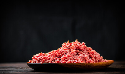Fresh minced meat on the table on a plate. 