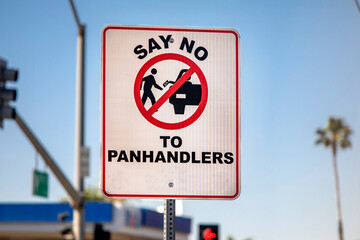 A sign with a pictograph discouraging panhandling