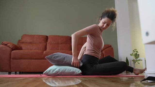 Adult caucasian woman practice restorative yoga on the floor at home