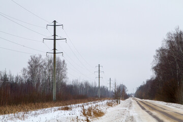 New large mast of an air power line close up, high voltage electricity pylon with thick wires and insulators, blue sky on background. Traditional energy. Electric power concept.