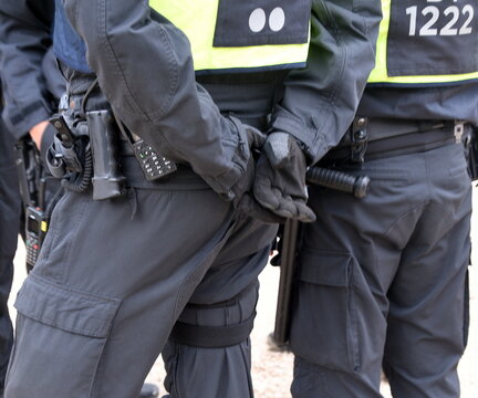 Polizisten in schwarzer Uniform und voller Ausr&uuml;stung im Einsatz