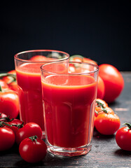 Glasses of tomato juice on the table. 
