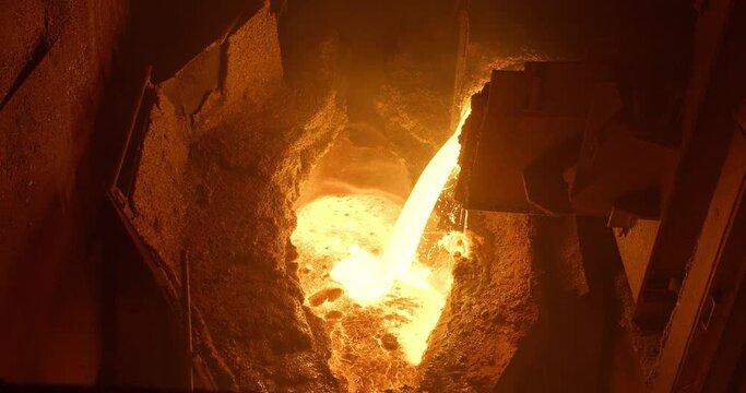 Metal casting process in metallurgical plant. Liquid metal pouring into molds
