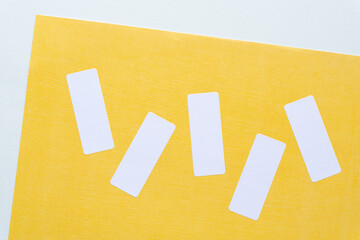 adhesive white paper stickers or labels on yellow scrapbook paper