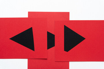 set of red cards with black shapes (mostly triangles) on white paper