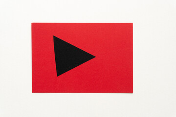 red card with black arrow isolated on blank paper