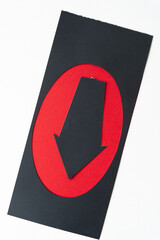 black paper stencil with oval frame opening and black paper arrow pointing down