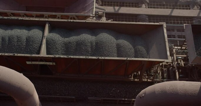 Aerial view of cargo train loaded with crushed stone materials at mining factory. Railway transportation of grinded limestone ore