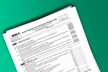 Form 8609-A documentation published IRS USA 07.17.2012. American tax document on colored