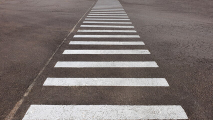 Obraz premium Pedestrian crossing marking on the road.
